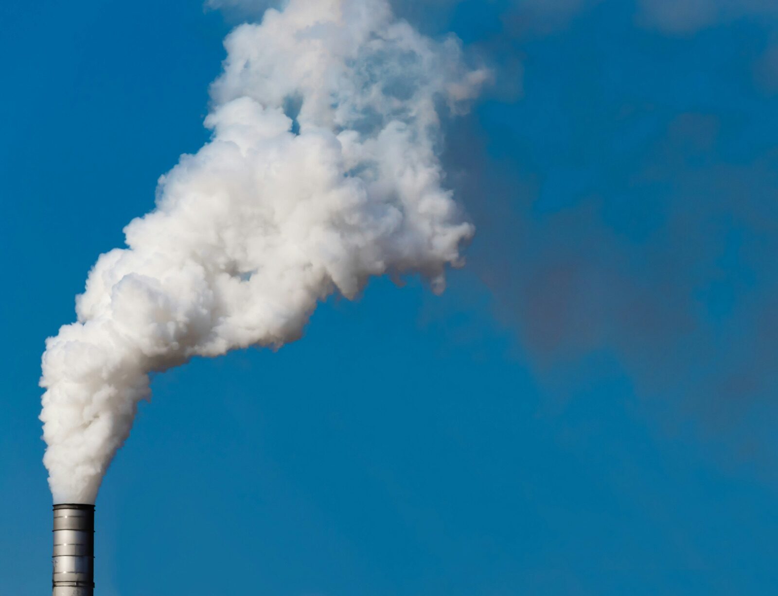 White smoke rising from factory chimney for Epo-Weld™ high emissive ceramic coating process vessel and stack
