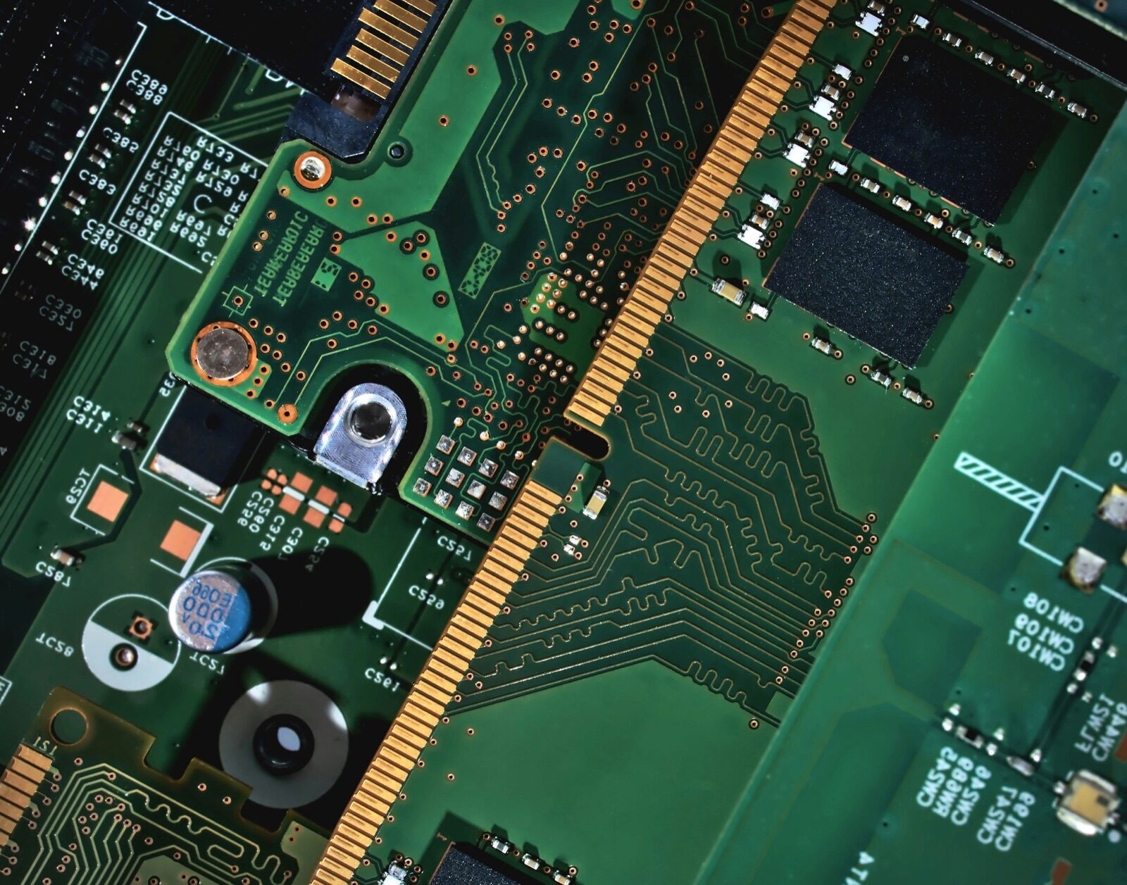 Green circuit board macro showing memory slots and component lanes for Epo-Weld™ HTE high-temperature epoxy electronic