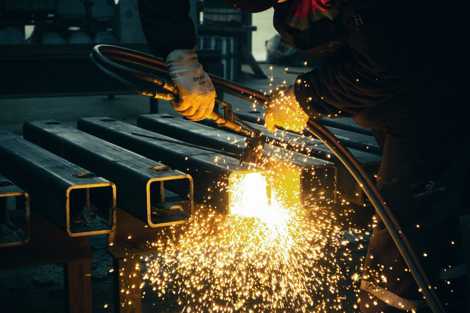 Welder with bright sparks on steel tube for Epo-Weld™ inorganic binder thermal spray and plasma sealing