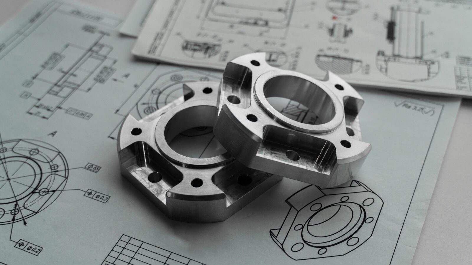 Precision metal parts on engineering blueprints for Pyra-Sil™ peelable silicone prototype and tooling protection