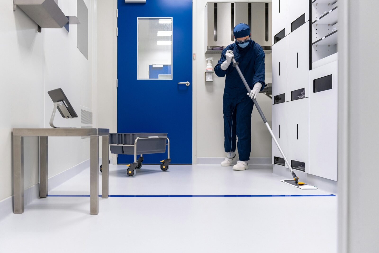 Cleanroom worker in protective suit at pharmaceutical facility for Incure Sniper™ medical device assembly